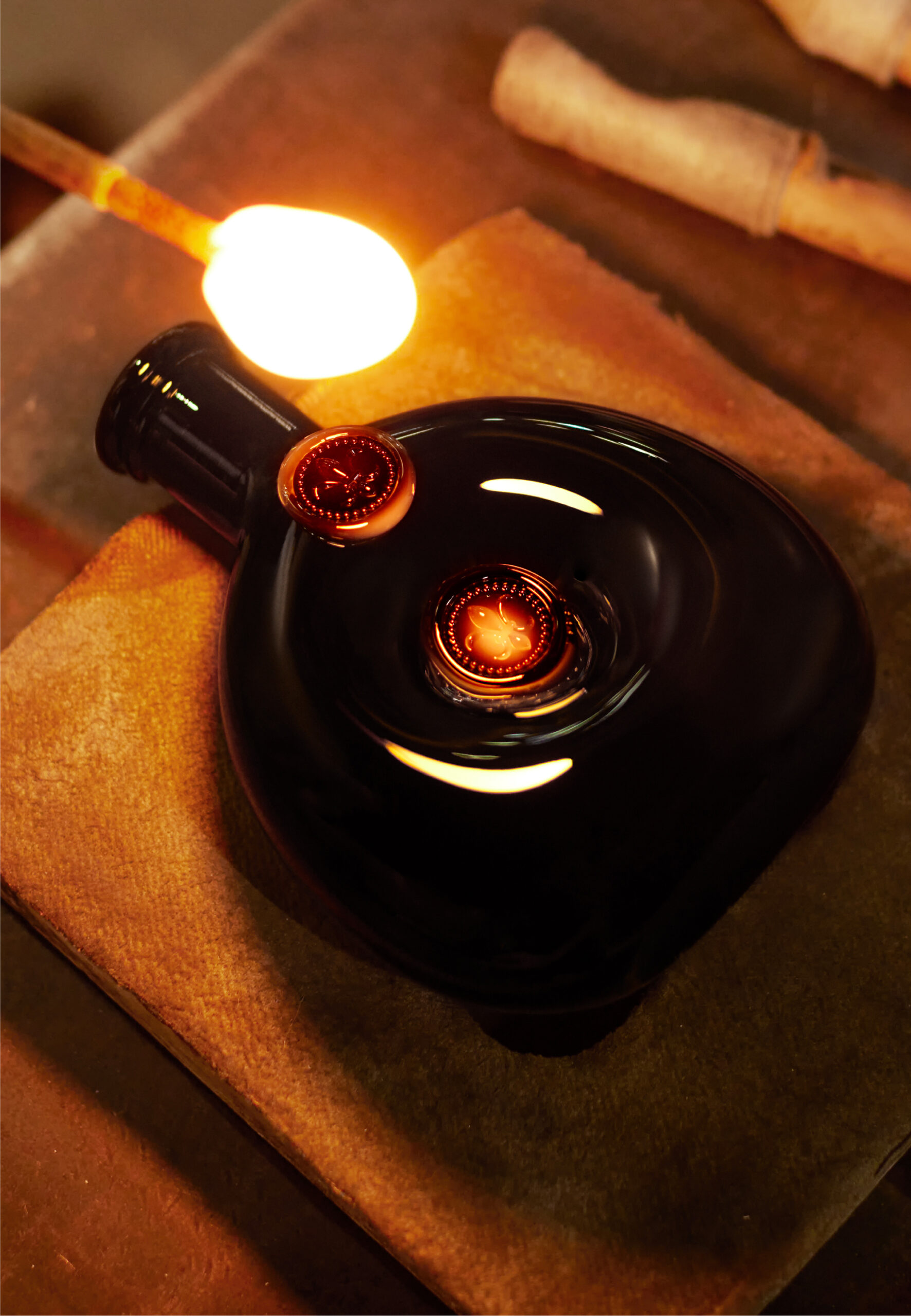 Louis III Rare Cask 42.1 in a cognac black Baccarat decanter laid on table in Venice and glass blower