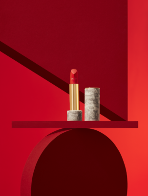 Open Dior Red Rouge Premier Lipstick on pedestal with lid